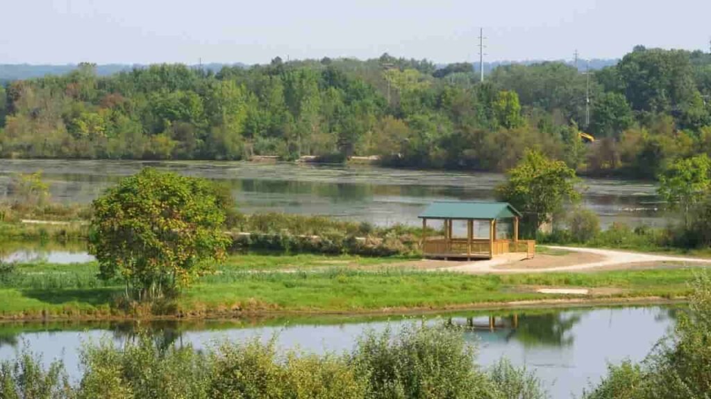 Scenic view of a popular park in Rittman, Medina County, Ohio, with green lawns, walking paths, and a clear blue sky.
